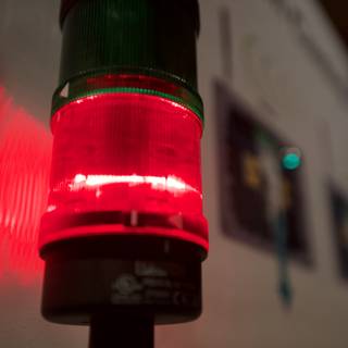 Red Traffic Light Illuminates Wall