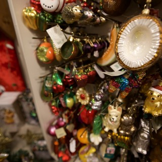 Colorful Christmas Ornament Collection Display on White Shelves