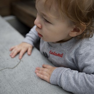 Peaceful Toddler Resting on Gray Couch