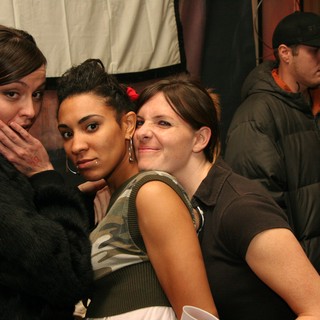 Three Friends Posing Together at Indoor Event