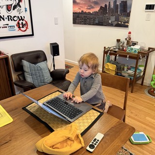 Toddler Working at Laptop in Modern Urban Apartment