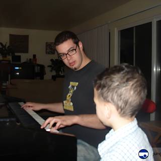 A Joyful Duet: Father and Son Play the Piano Together