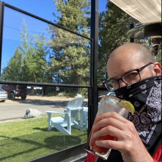 Bandana-Clad Dave B Enjoying a Drink Outdoors