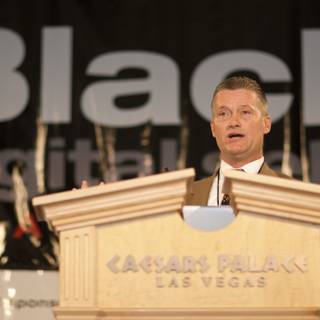 Man addressing a crowd from a podium