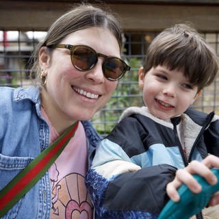 Mother and Son Smiling Together at Outdoor Venue