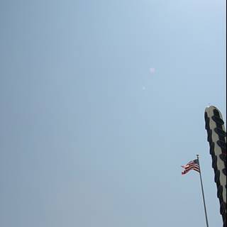 American Flag flying high alongside a kite