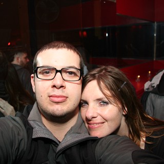 Friends Pose Together at Dimly Lit Nightclub