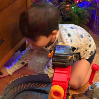 Christmas Morning Play: Child with Toy Train Set
