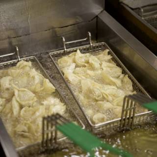 Dumplings sizzling in the fryer