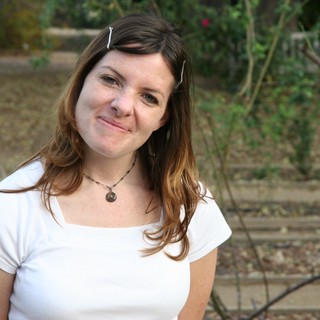 Young Woman Smiling Outdoors in Warm Afternoon Light