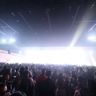 Massive Indoor Rave Crowd Bathed in Blinding Stage Light