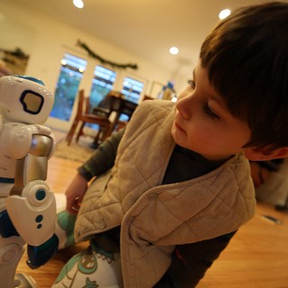 Toddler's Fascination with Interactive Robot Toy at Home