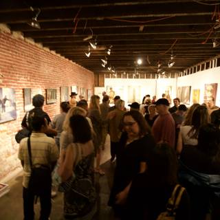 Art Enthusiasts Admire Paintings in Urban Gallery