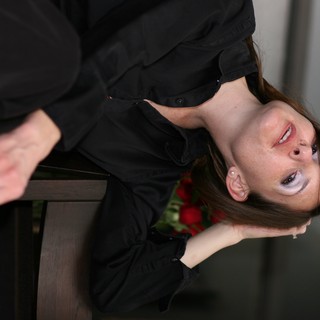 Pensive Woman in Black Gazing Upward Dramatically