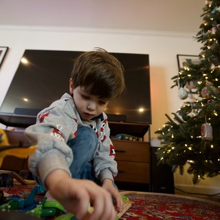 Christmas Morning: Boy Playing with New Toys