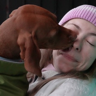 Tender Moment Between Woman and Puppy