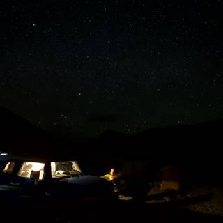 Night Adventure with Two Cars and Starry Skies