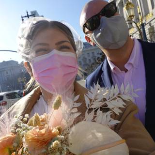 Masked Couple Walks Amidst Flower Beds on the Street