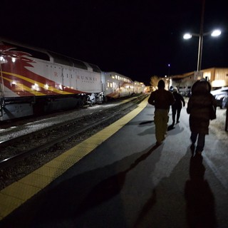 Passengers Boarding Rail Runner Express at Night