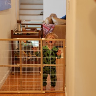 Toddler Behind Safety Gate at Home