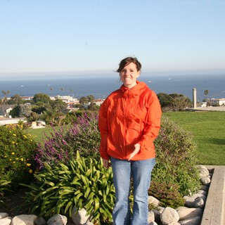 Woman in Orange Jacket at Coastal California Overlook