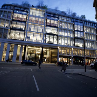 Modern Glass Office Building Illuminated at Dusk in London