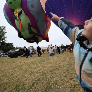 Child Marvels at Caterpillar Hot Air Balloon Festival