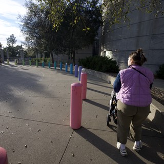 Woman Walking Past Colorful Posts at Chabot Space Center