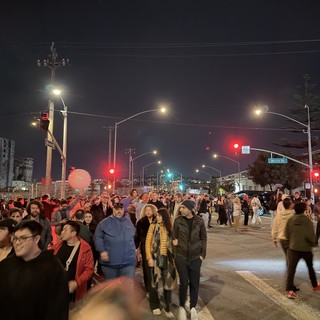 Night Street Scene with Large Crowd Gathering at Intersection