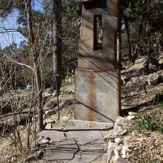 Weathered Metal Sculpture Gateway in Forest Garden