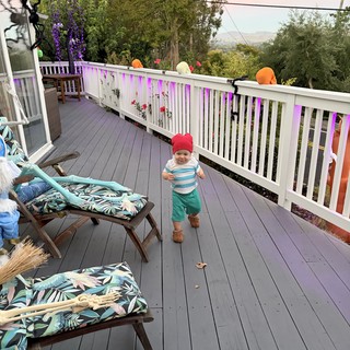 Toddler's Halloween Adventure on Decorated Deck