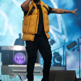 Solo Performance by Drake Caption: Entertainer Drake lights up the stage in his signature yellow vest during his solo performance at Coachella 2017, captivating the crowd with his music and powerful presence.