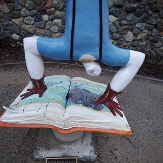 Whimsical Public Art: Reader Standing Over Open Book
