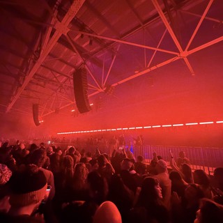 Red-Lit Crowd at Electronic Music Concert Event