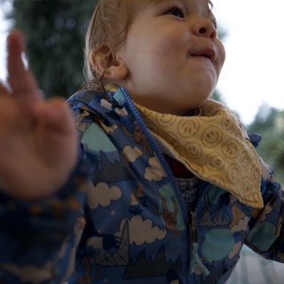 Joyful Toddler Reaching Upward with Wonder