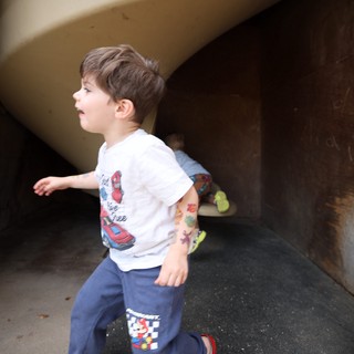 Young Boy Running Through Tunnel at Fantasyland