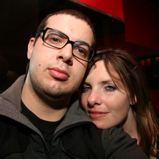 Two Friends Pose at a Dimly Lit Nightclub