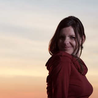 Woman in Red Smiling at Golden Hour Sunset