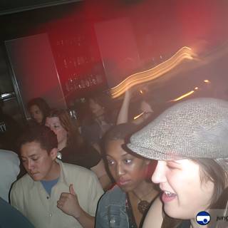 Nightclub Party with Hat-Wearing Man