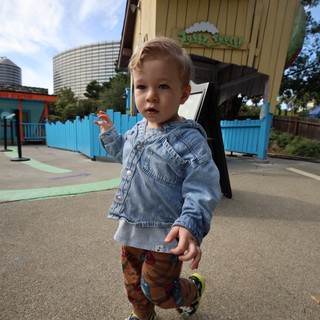 Toddler Exploring Colorful Playground at Theme Park