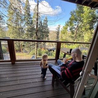 Father and Toddler Share Peaceful Deck Moment