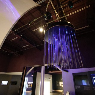 Interactive Space Museum Installation with Purple Fiber Optic Display