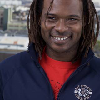Dreadlocked Man Smiling By Waterfront