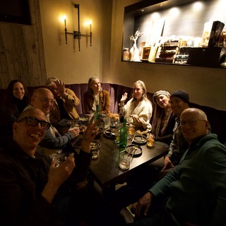 Friends Gathering for Dinner at Cozy Restaurant