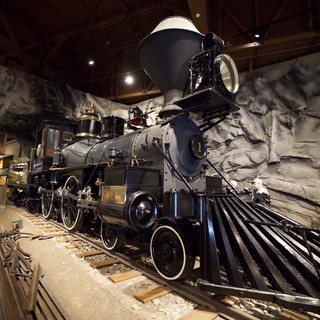 Historic Steam Locomotive Display in Cave-Like Museum Setting