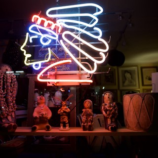 Neon Kokopelli Display with Pueblo Pottery and Folk Art