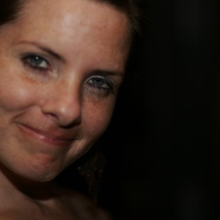 Penelope's Coy Smile in Dramatic Low Light