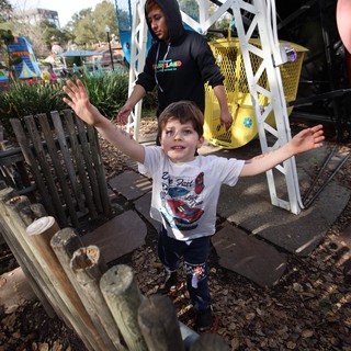 Young Boy's Joyful Moment at Theme Park Playground