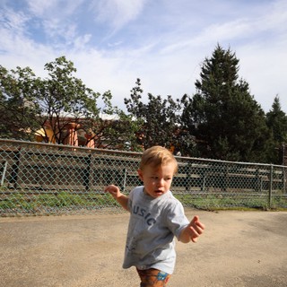 Toddler Running Joyfully at Outdoor Play Area