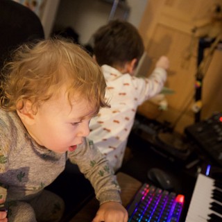 Young Child Captivated by Colorful Gaming Keyboard